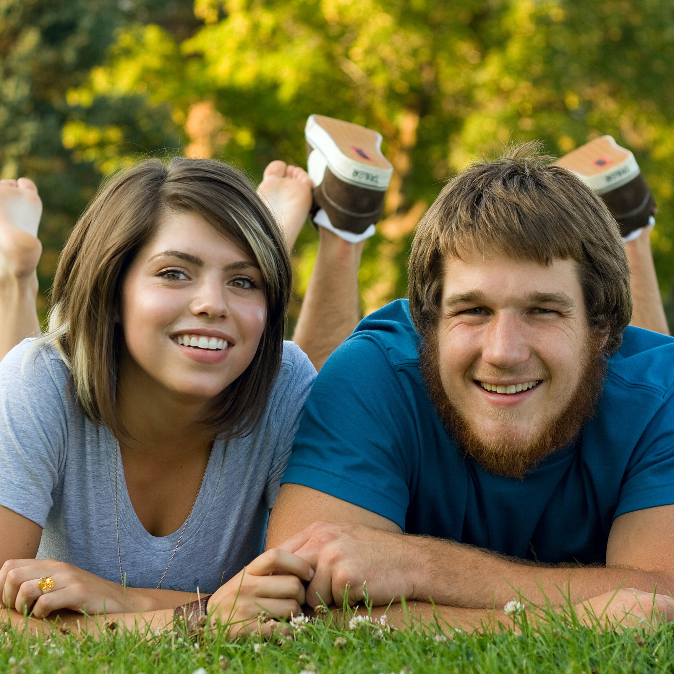 Couple Facing Camera On Grass