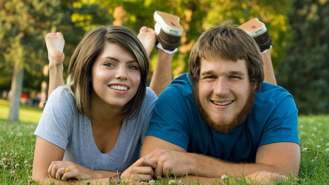 Couple Facing Camera On Grass