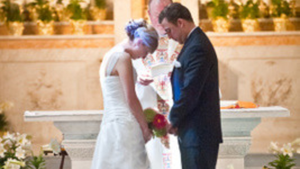 Wedding Couple Bowing In Prayer